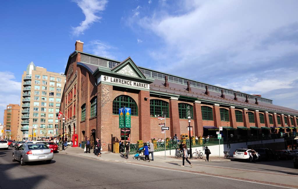 Is Toronto Worth Visiting in 2024? Local Guide 7 st lawrence market with red brick building and people going to the market to shop in Toronto