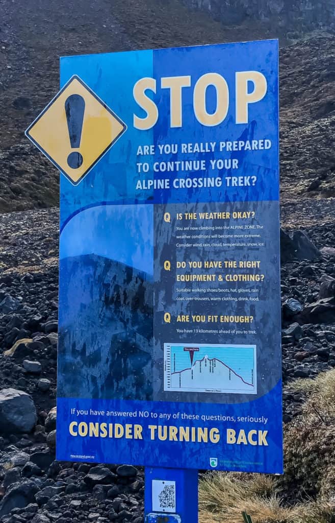 How to Hike the Tongariro Alpine Crossing and Why You'd Want To 13 Warning sign about Tongariro Crossing gear and weather.