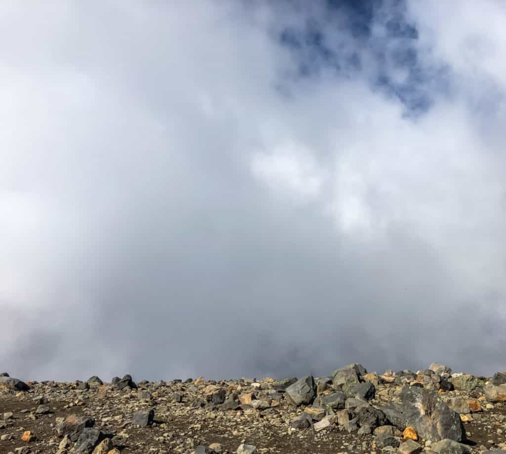 How to Hike the Tongariro Alpine Crossing and Why You'd Want To 7 Clouds blocking the view of Mount Doom from the Tongariro Alpine Crossing summit