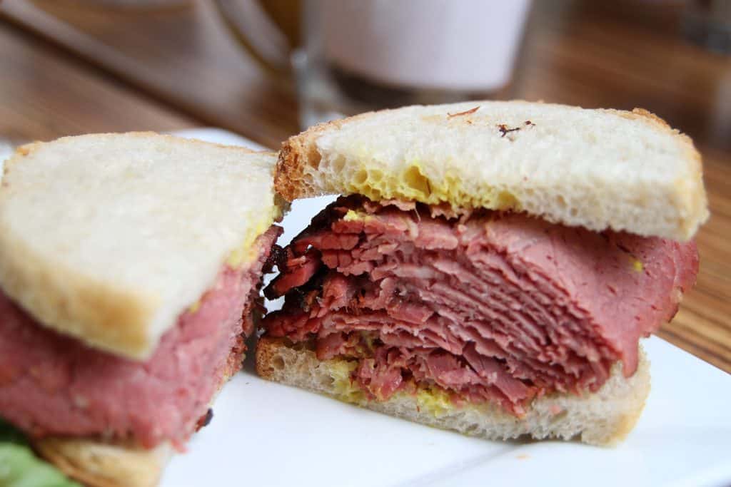 Canada Cuisine to Try: Traditional Food Canada is Famous For 11 Montreal smoked meat sandwich with mustard on white bread that Canada is famous for