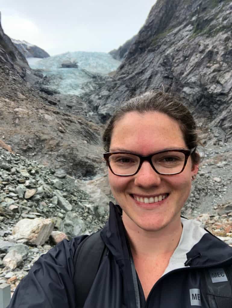 Franz Joseph Glacier Walk: The Cheapest Way to See the Franz Josef Glacier in New Zealand 8 Nina posing in front of the Franz Josef Glacier from the free walking trail