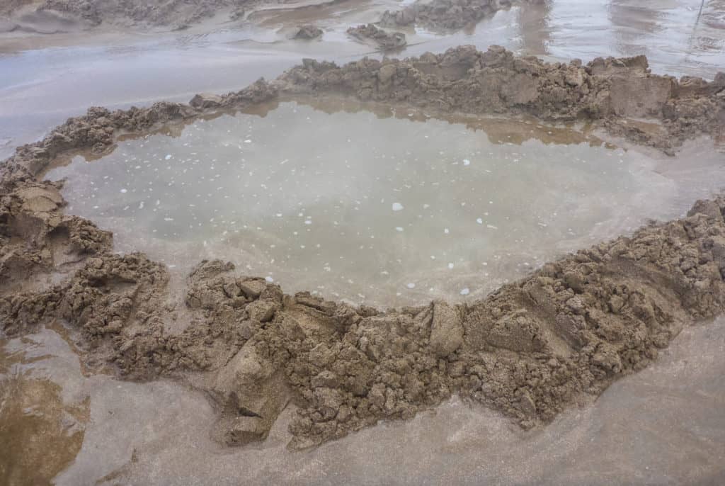 Hot Water Beach: A Guide to the Renowned Beach 7 View of a full hot pool in the sand at Hot Water Beach