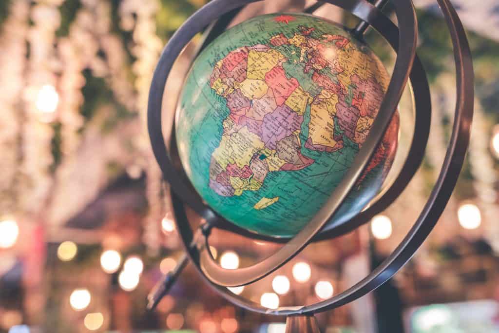 45 Pros and Cons of Living in Canada from a Canadian 15 globe twirling to show Canada