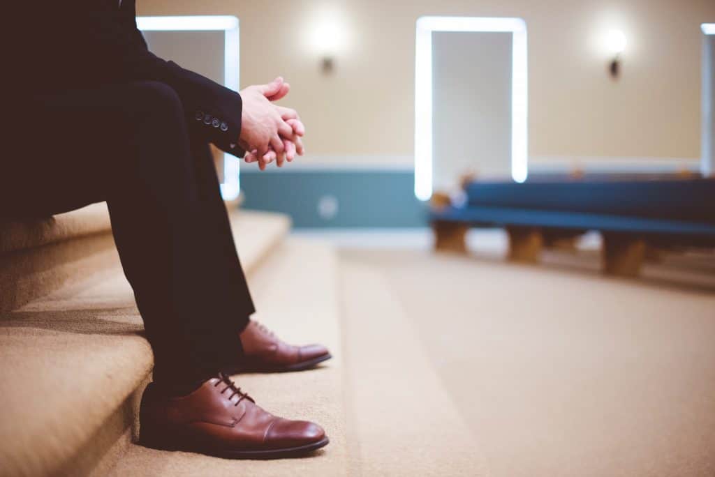 45 Pros and Cons of Living in Canada from a Canadian 2 Man sitting in a hospital waiting room in Canada