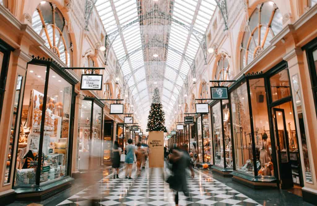 45 Pros and Cons of Living in Canada from a Canadian 12 Canadian mall with store signs around a Christmas tree