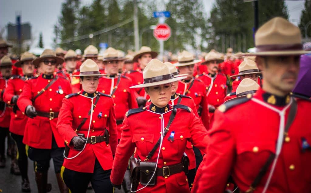 45 Pros and Cons of Living in Canada from a Canadian 6 Canadian mounties marching in line and protecting the people in the country