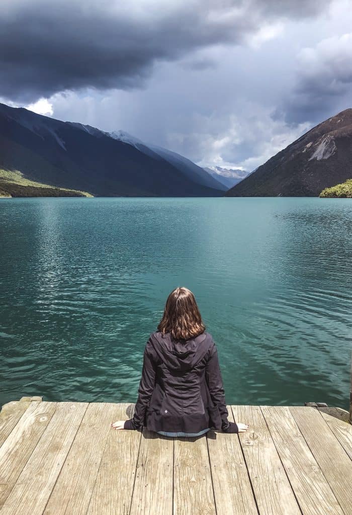 What is the Best Time of Year to Visit New Zealand? 3 Girl on a dock looking out over a turquoise lake - Autumn - What is the best time of year to visit New Zealand?