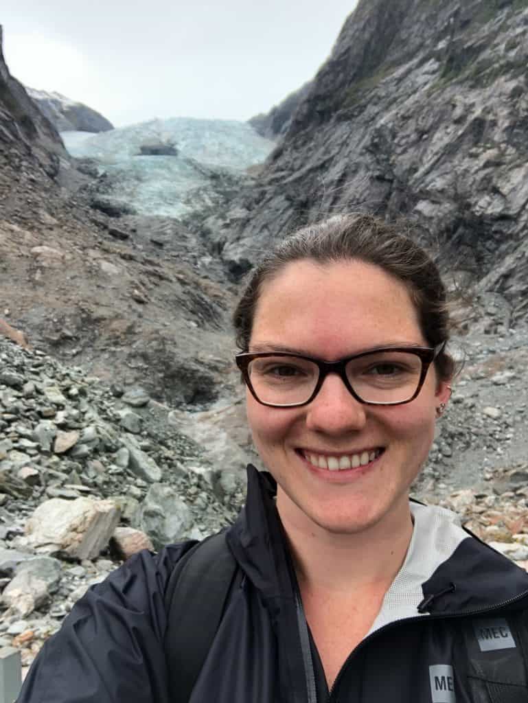 18 Best Things to Do In South Island of New Zealand 2024 5 Nina smiling in a selfie at Franz Josef Glacier, a South Island tourist attraction