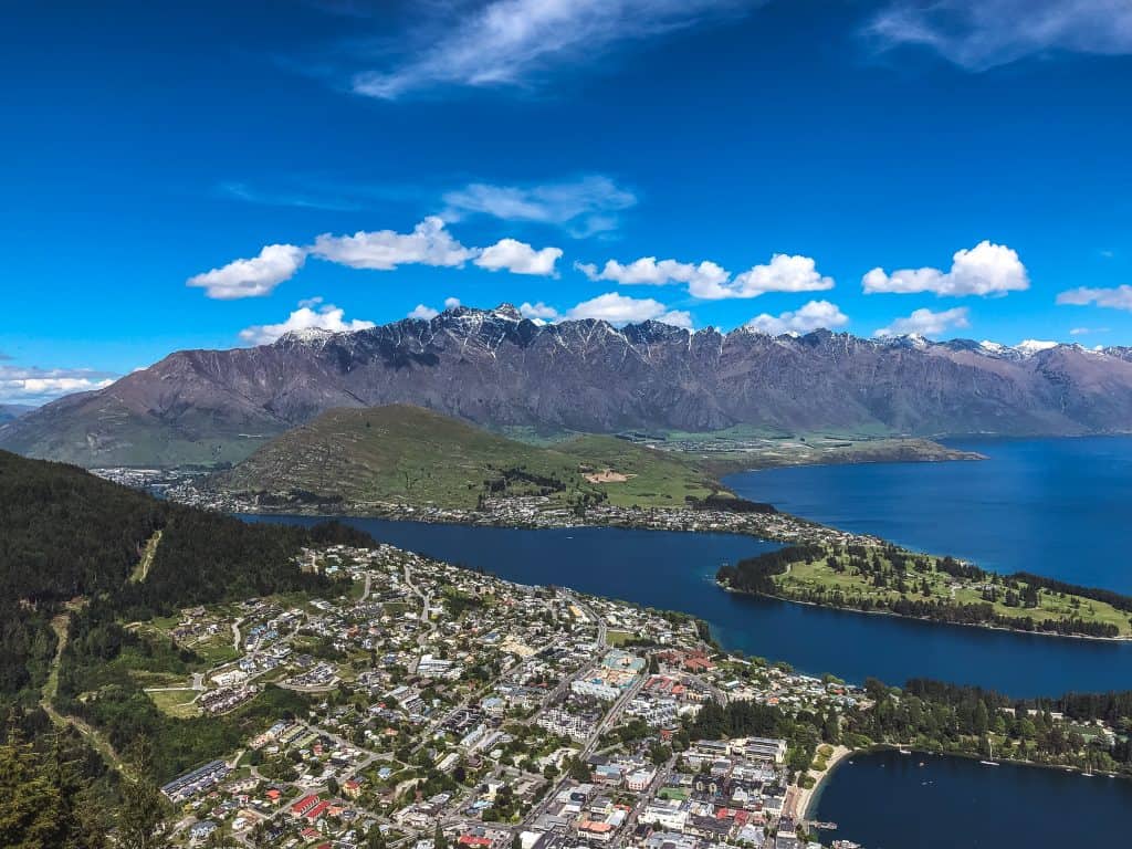 18 Best Things to Do In South Island of New Zealand 2024 14 Queenstown from above with a view of Mt. Aspiring in the background