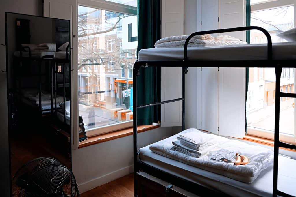 57 New Zealand Travel Tips (2024 Local's Guide) 12 Hostel dormitory with bunk beds
