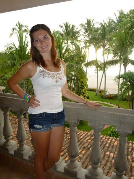 25 Pros and Cons of Living in Costa Rica in 2024 7 16 year old Nina on a balcony in Costa Rica overlooking palm trees and the beach.
