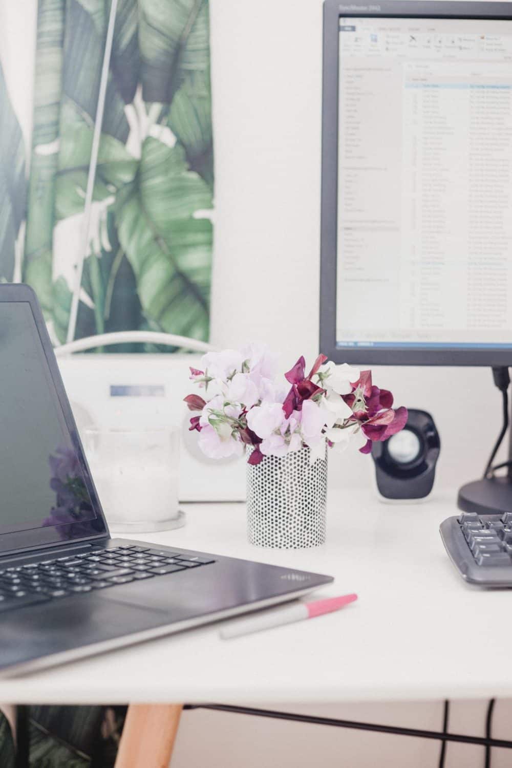 15 Unique Solo Staycation Ideas for Singles 18 Work desk with two computer screens and fresh pink flowers