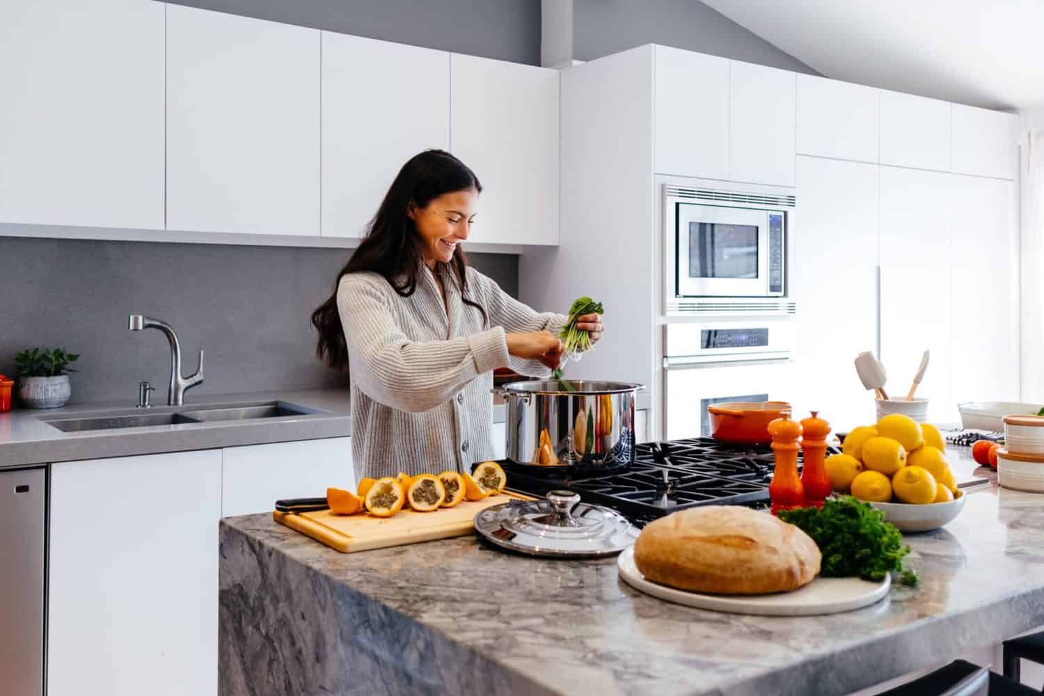 15 Unique Solo Staycation Ideas for Singles 4 Girl cookies in a white kitchen by putting green herbs in a pot