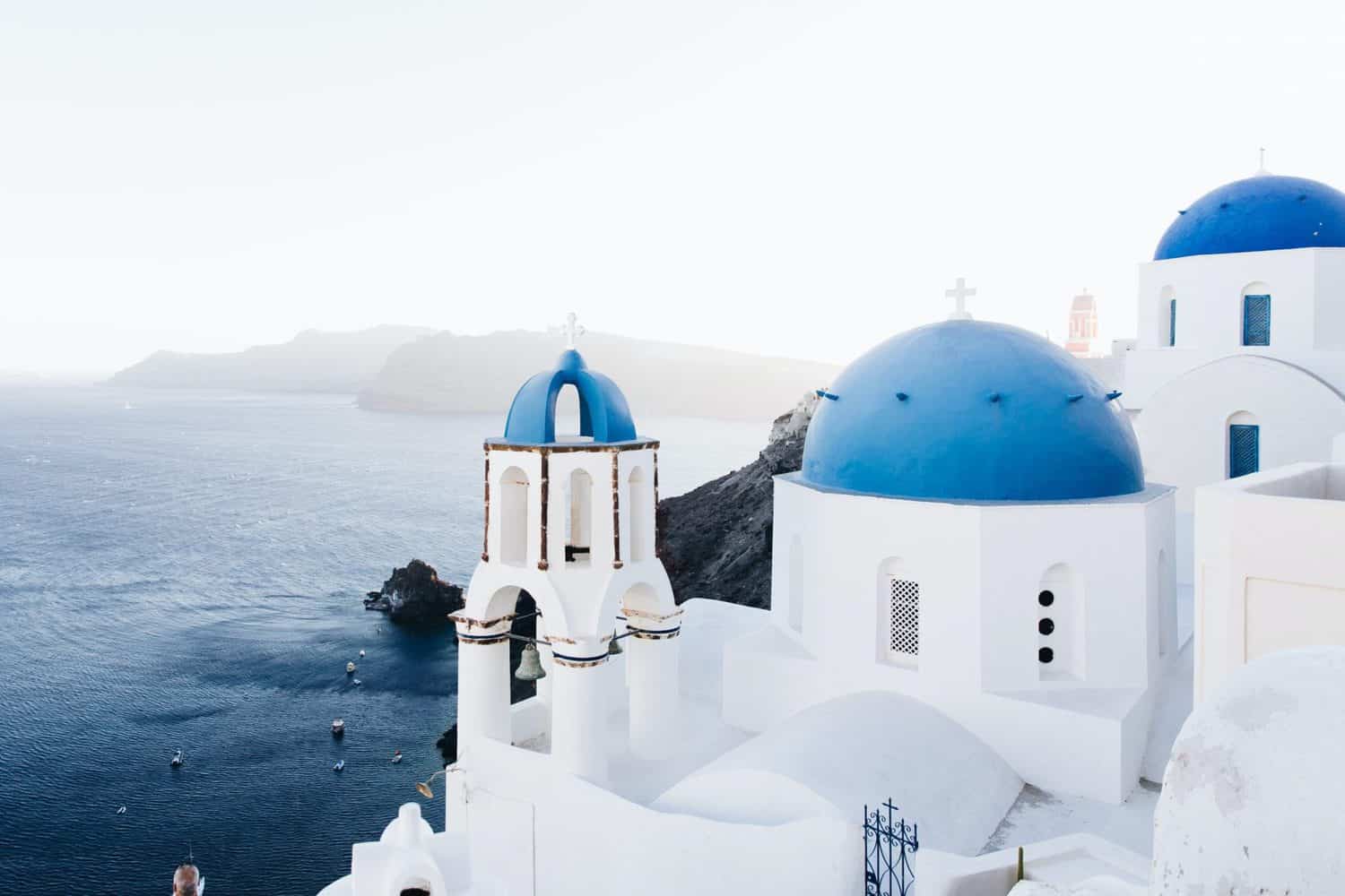 15 Unique Solo Staycation Ideas for Singles 7 Greek white and blue buildings against the stunning blue ocean