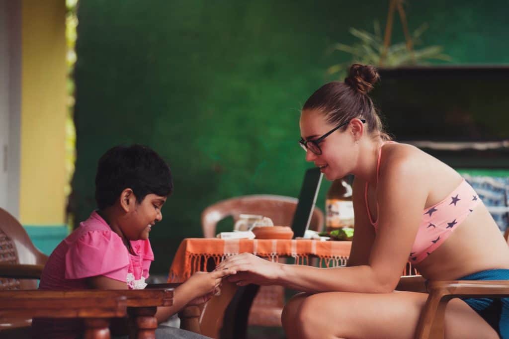 29 Greatest Ways to Make Money Travelling the World 6 Woman teaching english to a small boy abroad