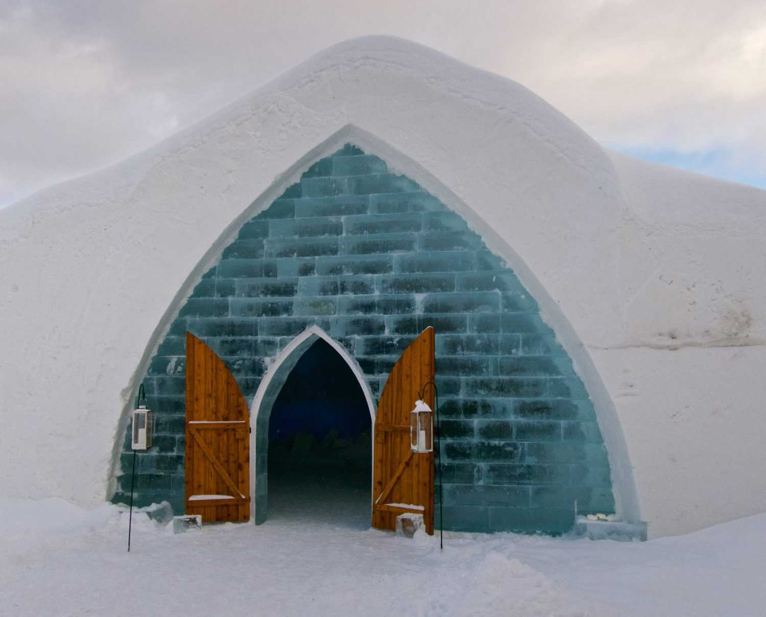 20 Common Misconceptions About Canada: Myths & Stereotypes 2 Igloo built out of snow with ice bricks around a wooden door to show the Canadian myth that we live in igloos