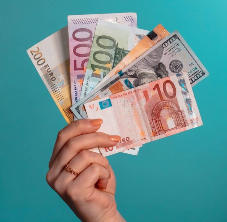 29 Greatest Ways to Make Money Travelling the World 44 how to make money while travelling - woman holding euros
