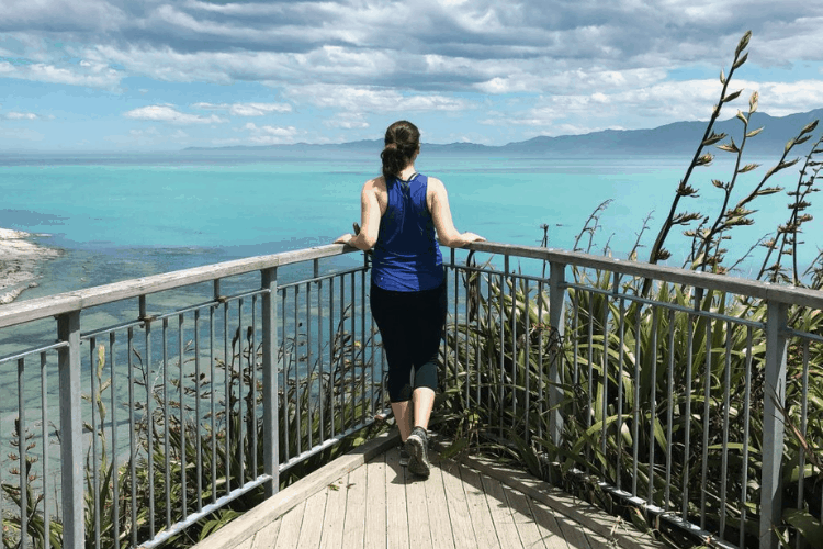 Cost of Living in New Zealand in 2024 (Local's Guide) 2 Nina overlooking the water in Kaikoura from the back while living in New Zealand