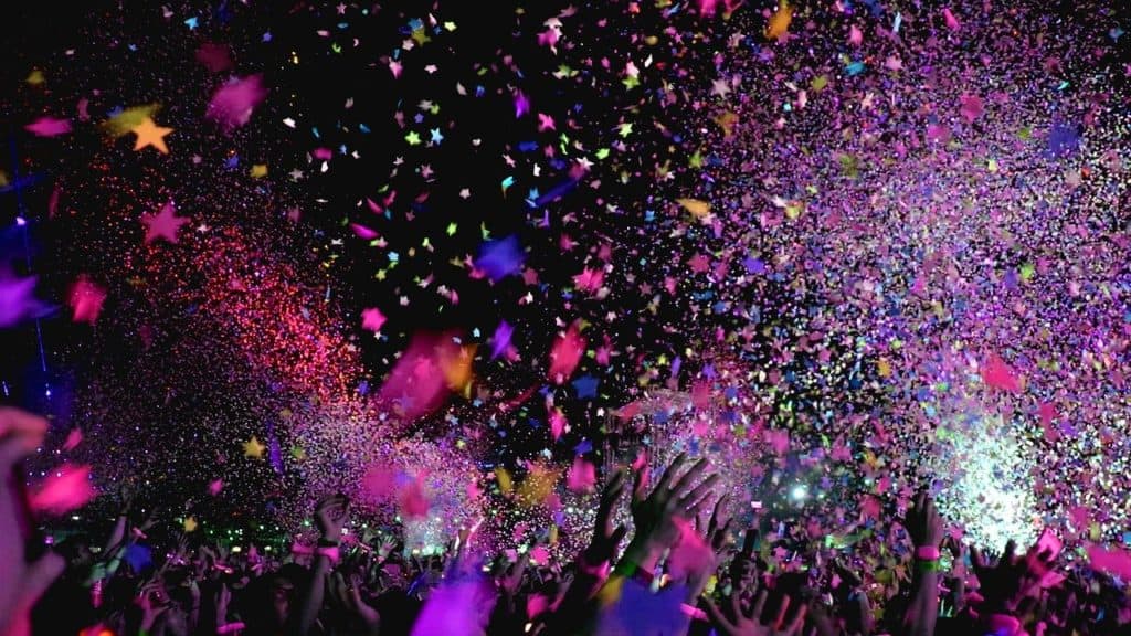 25 Pros and Cons of Living in New Zealand 2 Image of confetti being thrown at an outdoor party