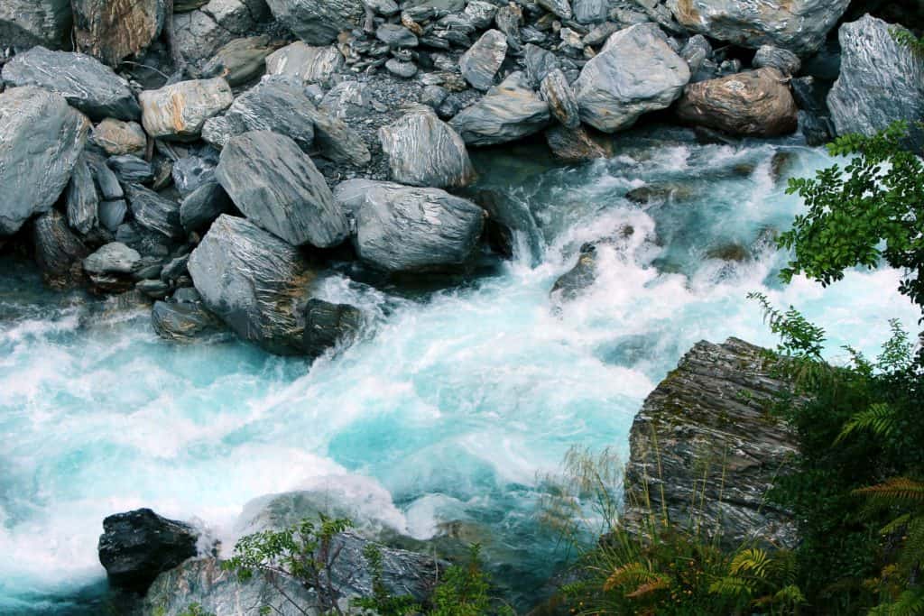 25 Pros and Cons of Living in New Zealand 14 Blue rapids in New Zealand