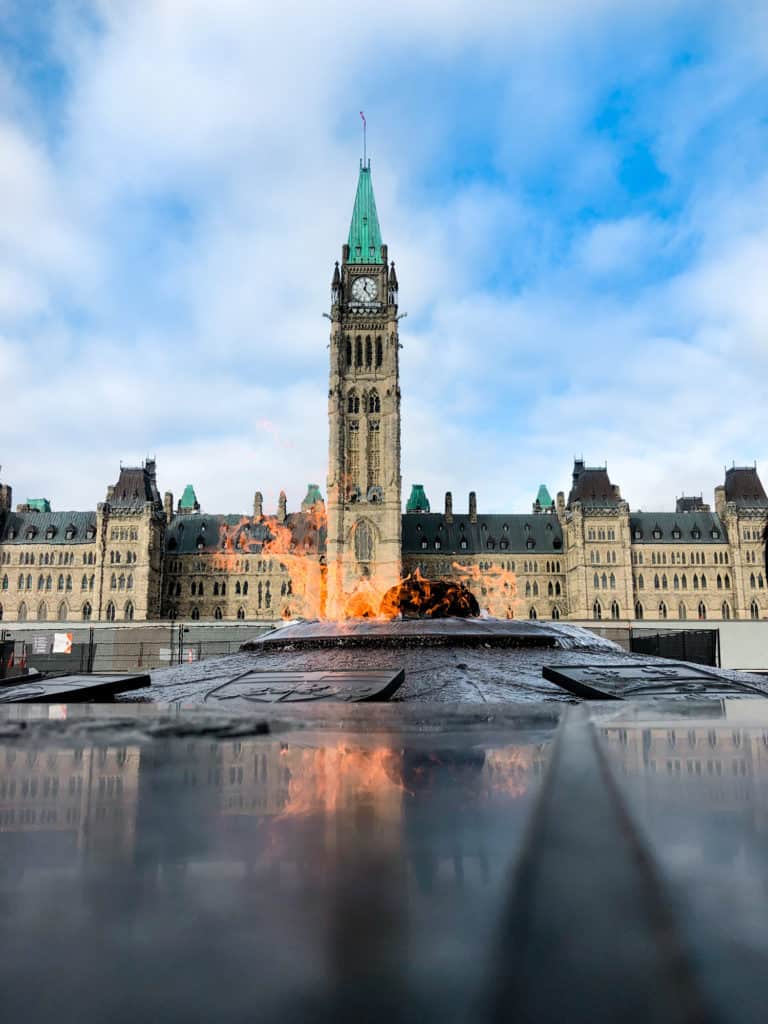 View of parliament hill with the eternal flame burning in front of parliament.