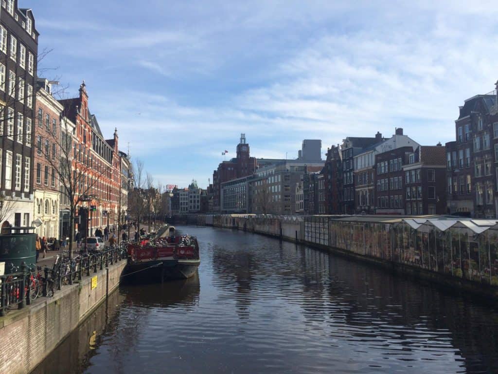 What You Need to Know Before Travelling to Amsterdam Alone 9 View of a single boat on the Amsterdam canal