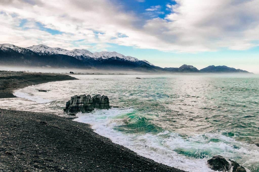 Best Place to Swim with Wild Dolphins in New Zealand 1 View of Kaikoura ocean and mountains where you can swim with wild dolphins