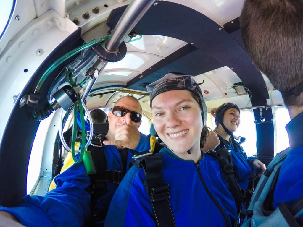 Skydiving in Taupo, New Zealand: 15,000 ft of Fun 4 Nina and Rhys smiling at the camera on the plane