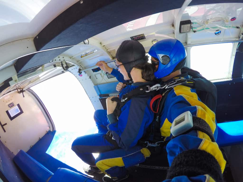 Skydiving in Taupo, New Zealand: 15,000 ft of Fun 5 Nina on Rhys' lap as they prepare to skydive out the door of the plane in New Zealand