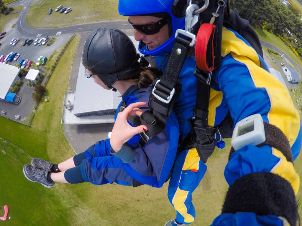 Skydiving in Taupo, New Zealand: 15,000 ft of Fun 13 Nina sticking her legs straight forward as they prepare to land from the skydive