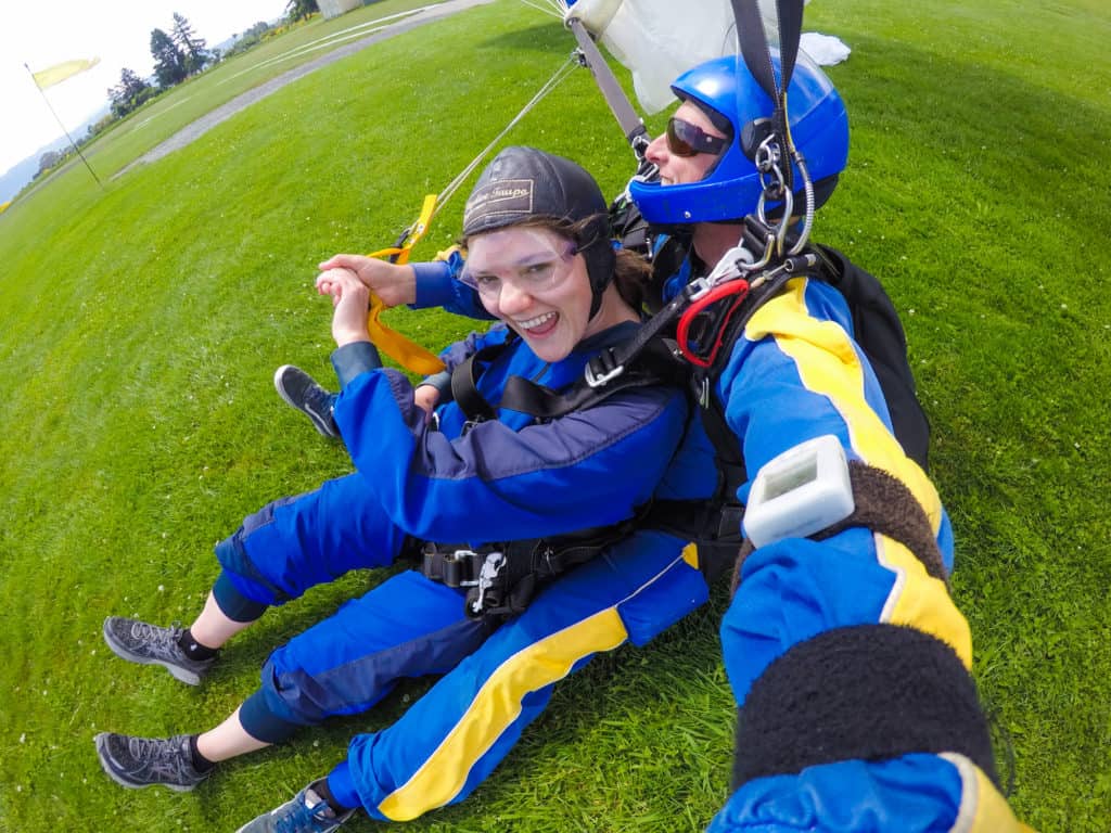 Skydiving in Taupo, New Zealand: 15,000 ft of Fun 14 Nina grinning at the camera as Rhys congratulates her for completing the skydive