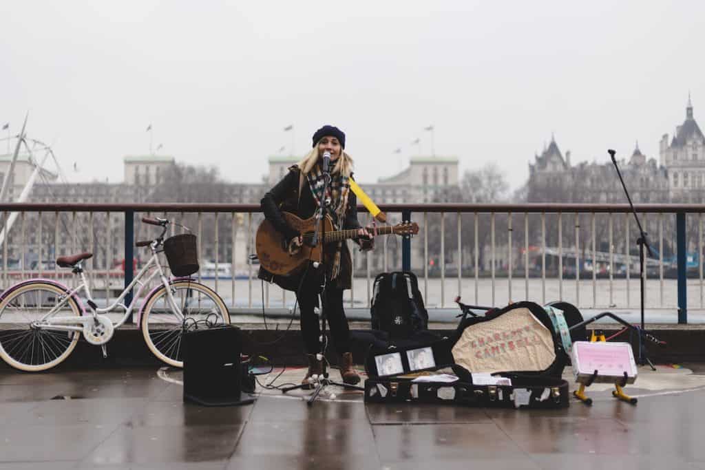 29 Greatest Ways to Make Money Travelling the World 9 Woman busking on the street