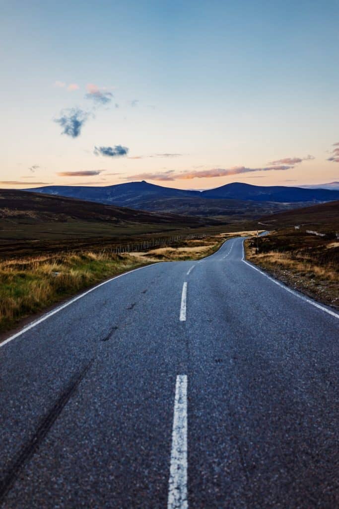 Best Quebec Road Trip (An Epic 2 Week Itinerary) 1 An empty road in the countryside at sunset.
