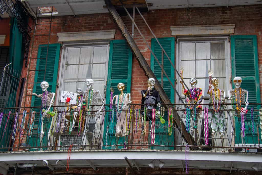 27 Best Weekend Getaways in the US 18 New Orleans city balcony with skeletons decorating it