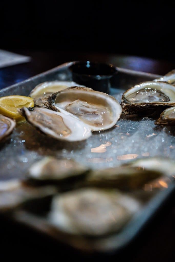 Canada Cuisine to Try: Traditional Food Canada is Famous For 9 Oysters in the half shell with lemon on the side to try in Canada