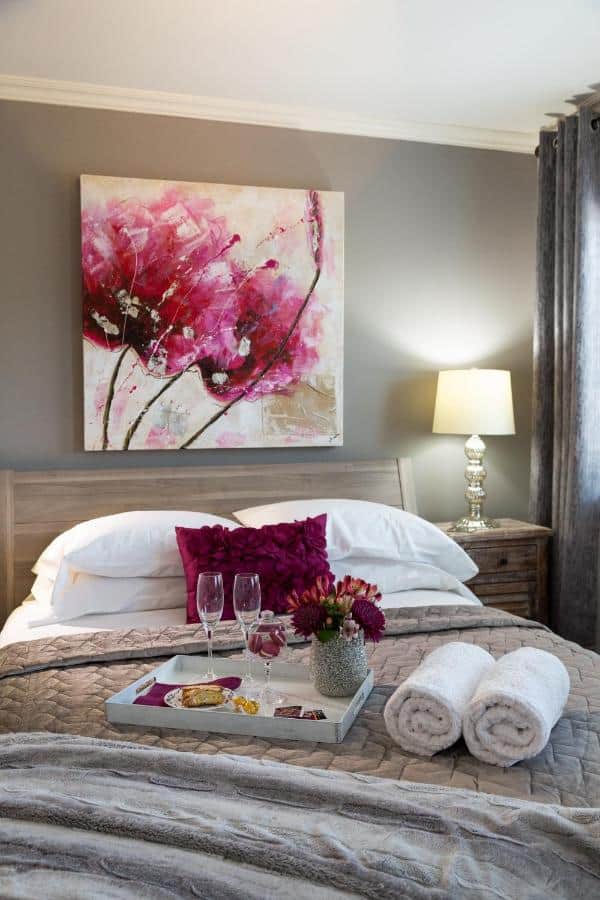 15 Best Hotels in Toronto with Private Hot Tubs (2024) 13 Comfy king bed with a tray of roses and champagne on top