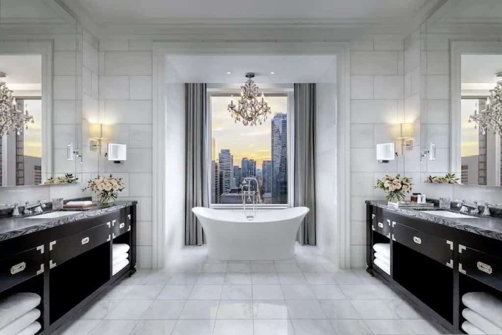 15 Best Hotels in Toronto with Private Hot Tubs (2024) 15 Jacuzzi suite bathroom with a view onto the Toronto skyline