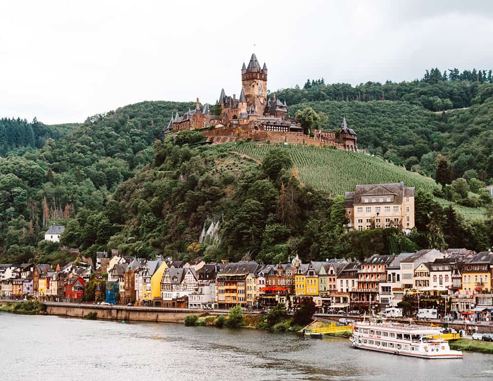 11 Fairytale Castles in Germany: Most Beautiful Castles to Tour 2 View of Cochem Palace, one of Germany's best castles, on a hill overlooking. thecity