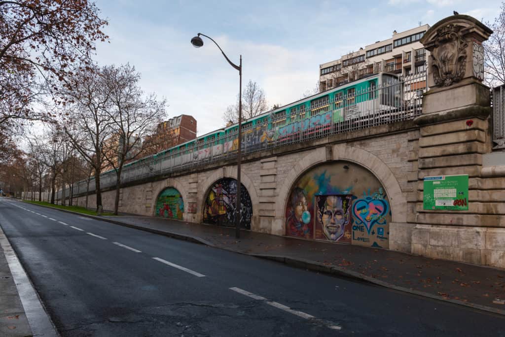 23 Pros and Cons of Living in France in 2024 6 Graffiti on the side of a street where the train pass by. Paris Transportation that is Always on Strike
