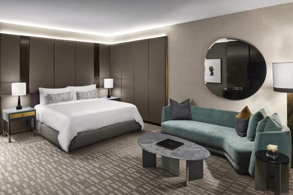 15 Best Hotels in Toronto with Private Hot Tubs (2024) 24 Modern hotel room with a turquoise sofa