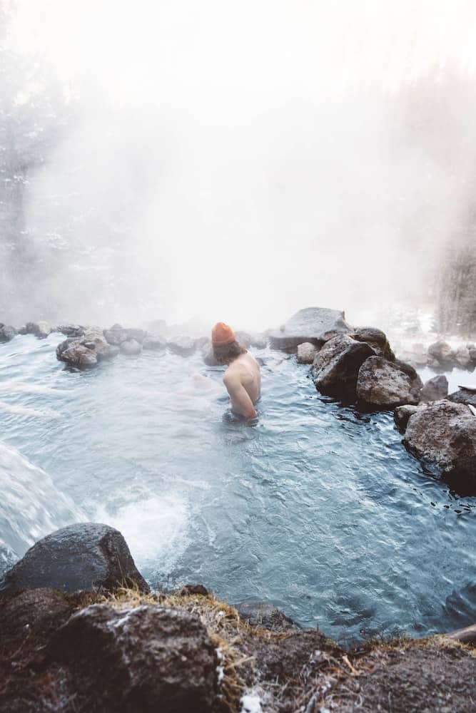 83 Bucket List Canada Things to Do in 2025 from a Canadian 19 Man soaking in a natural hot spring like the kind you can visit in British Columbia.