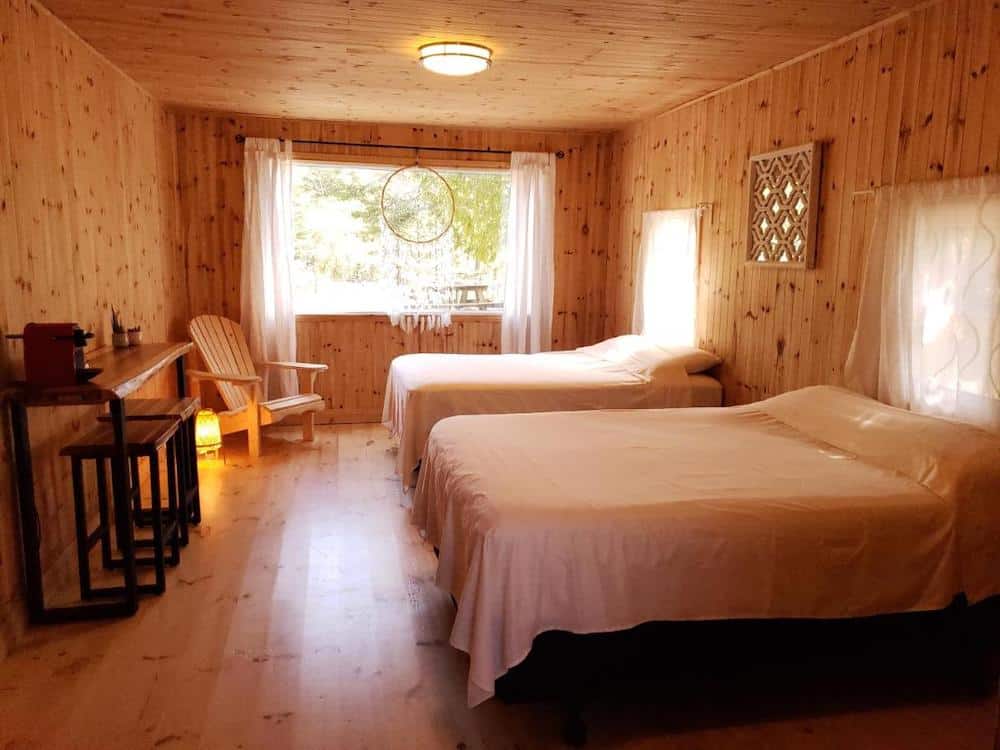 20 Cozy Cabins in Ontario for an Autumn Weekend Getaway 11 Interior of a cozy cabin in Tobermory for rent with two bed