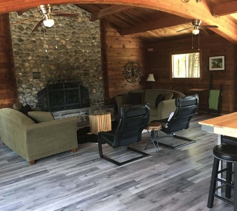 20 Cozy Cabins in Ontario for an Autumn Weekend Getaway 6 interior of a rustic cabin in Ontario with a stone fireplace