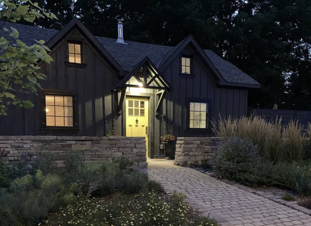 20 Cozy Cabins in Ontario for an Autumn Weekend Getaway 19 Front yard of a cabin with a soft glow from the lights making it look extremely cozy to visit in Ontario