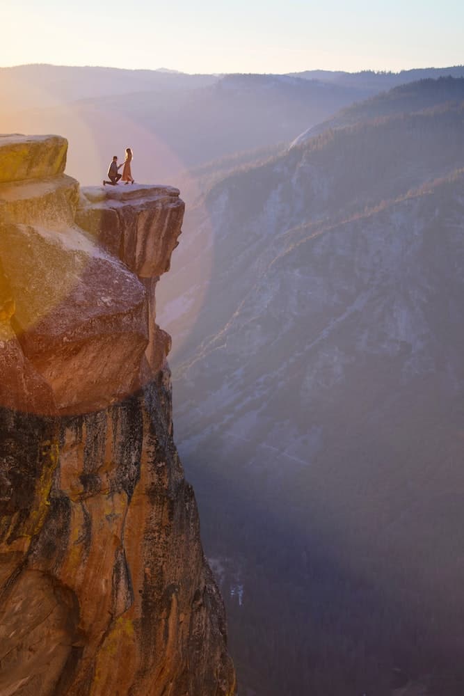 I Regret Moving to Another Country for Love: 7 Expat Stories 3 Man proposing to woman on a cliff abroad proving his love