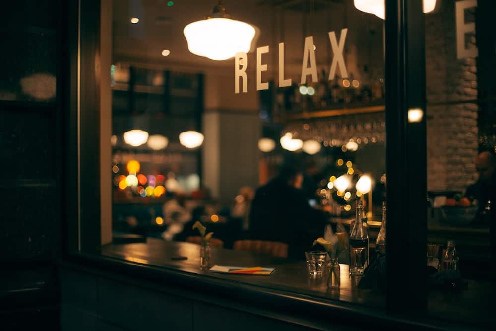Eating Alone While Traveling: Overcoming Fear of Eating Alone 9 "Relax" sign on a window of a restaurant