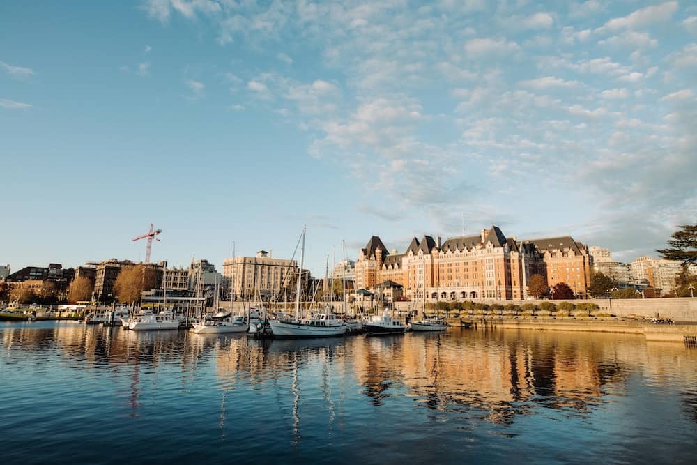 15 Best Places to Retire in Canada (From a Local Canadian!) 1 A dock by the water filled with small boats.