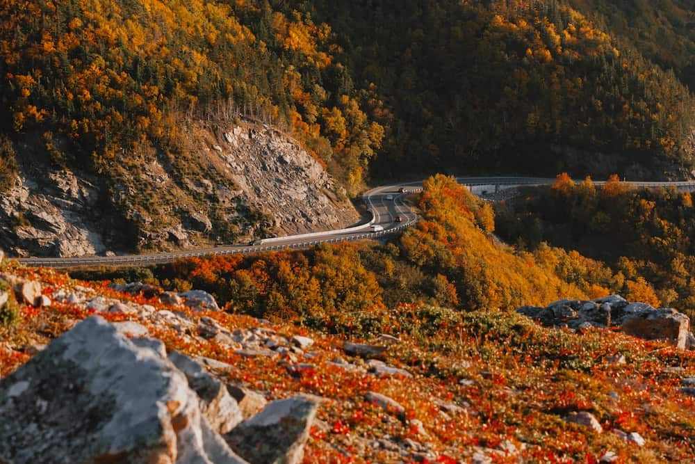 Canada in Autumn: 15 Reasons to Visit + Weather Guide 12 Red and orange autumn leaves on Canada's Cabot Trail in fall
