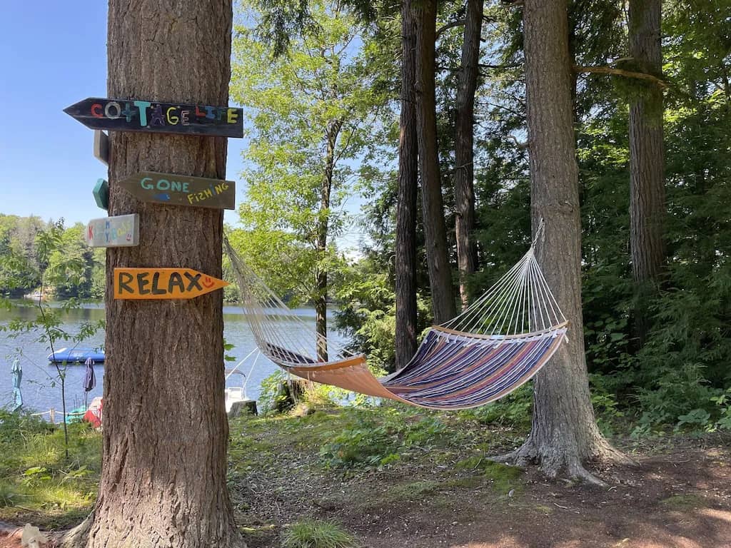 20 Top Airbnb Cottages in Muskoka for an Epic Getaway 15 Hammock between two trees at crane lake cottage in Muskoka.