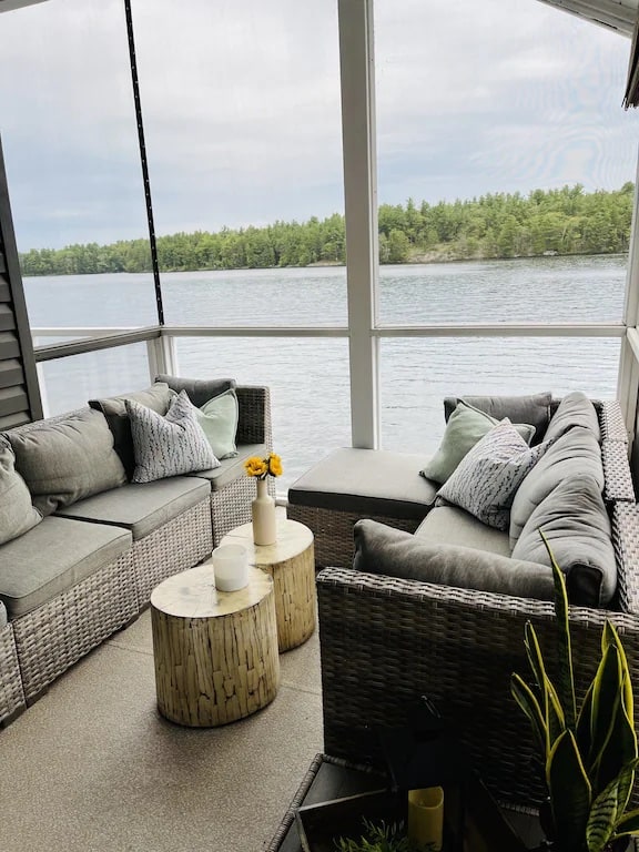 20 Top Airbnb Cottages in Muskoka for an Epic Getaway 48 Muskoka room at the Modern Executive Family Cottage. Two grey couches looking out over the lake.